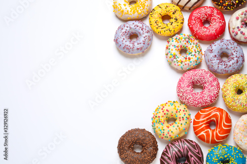 Fotobehang Delicious glazed donuts on white background, flat lay