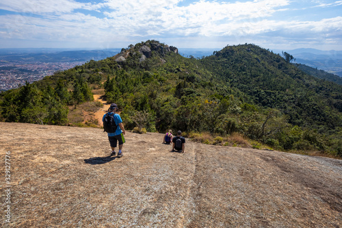 Hiker with backpack crossing rocky terrain in Pedra Grande Atibaia São Paulo Brazil