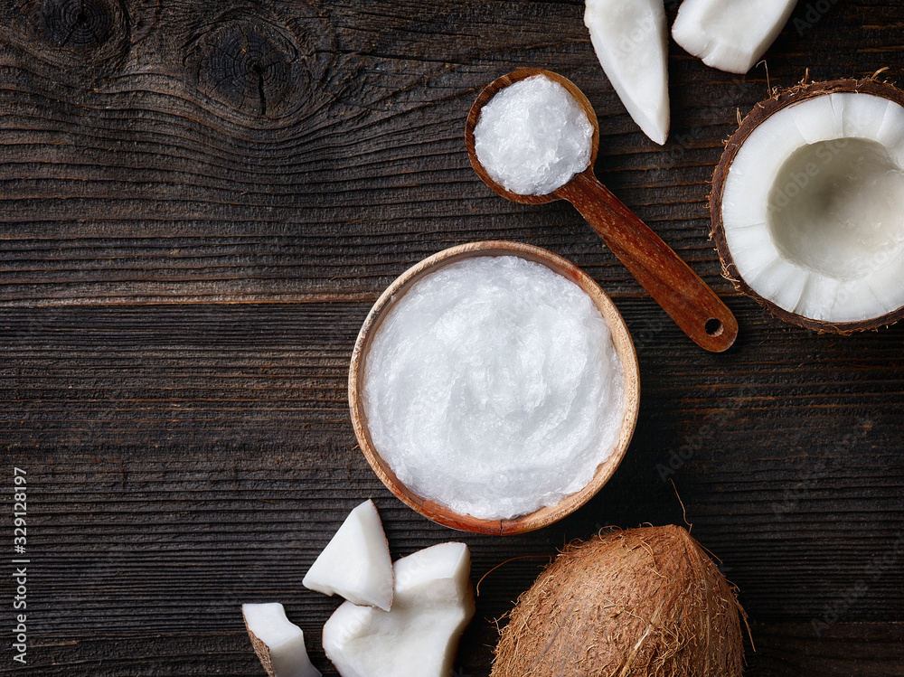 Bowl and spoon of coconut oil and fresh coconut Bowl and spoon of coconut oil and fresh coconut