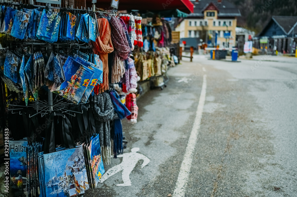 Souvenir shop with traditional postcards, magnets, bags, scarves, socks at the historic area of the mountain village Hallstatt. Austria. Unesco. Salzkammergut region. Travel and touristic concept