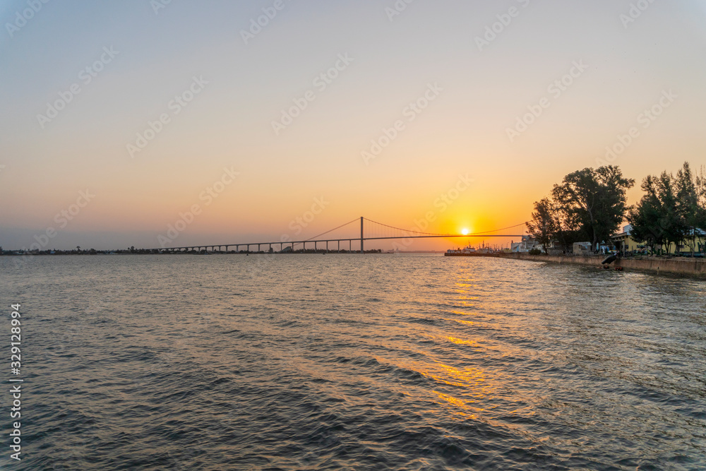 Fototapeta premium Sunset with The Golden Bridge in Maputo, Mozambique