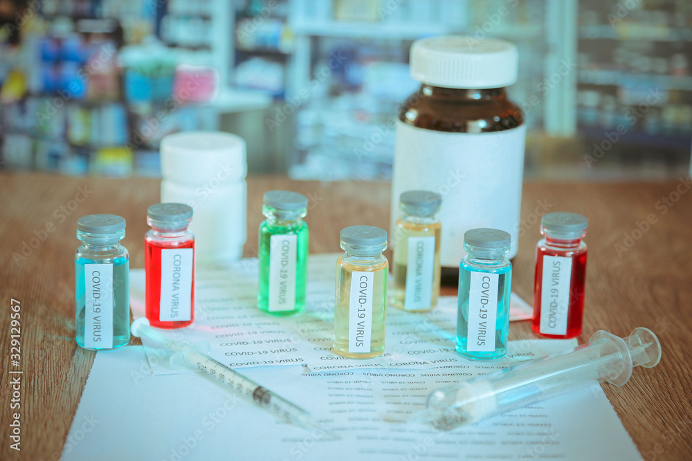 Syringe and illustrative of virus in background Medical Concept of composite photo of Corona Virus Outbreak Corona virus 2020 disease,COVID-19,nCoV Syringe and illustrative of virus in background Medical Concept of composite photo of Corona Virus Outbreak Corona virus 2020 disease,COVID-19,nCoV