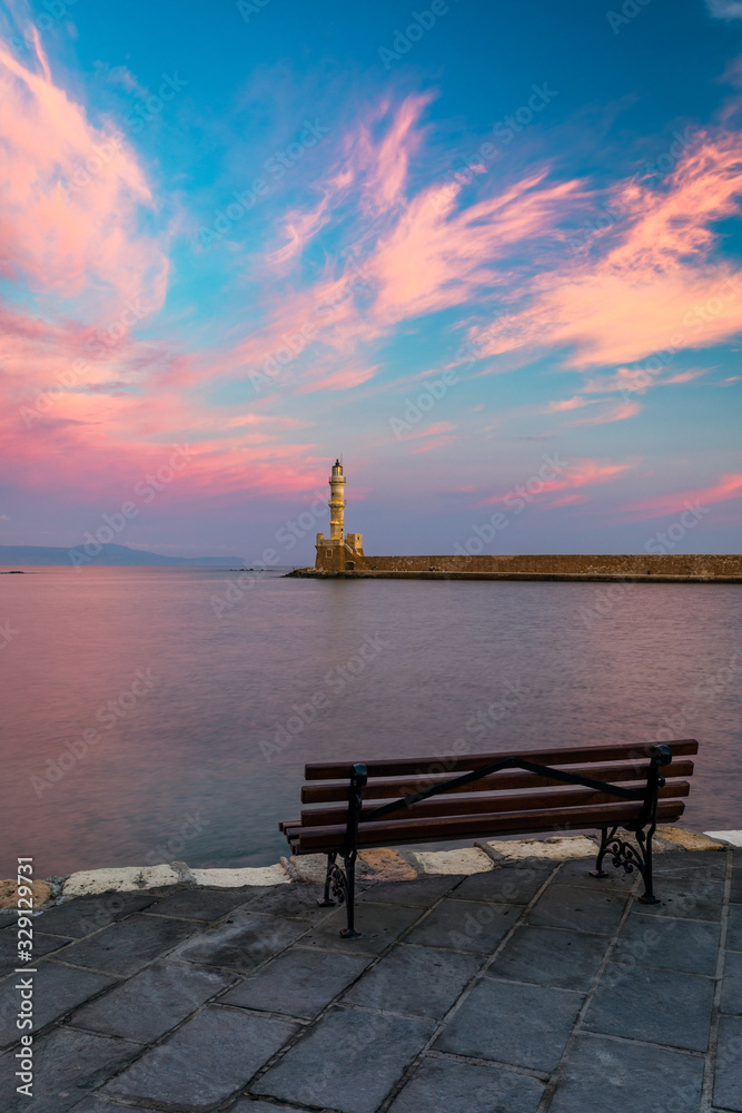 Venetian harbour and lighthouse in old harbour of Chania at sunrise, Crete, Greece. Old venetian lighthouse in Chania, Greece. Lighthouse of the old Venetian port in Chania, Greece.