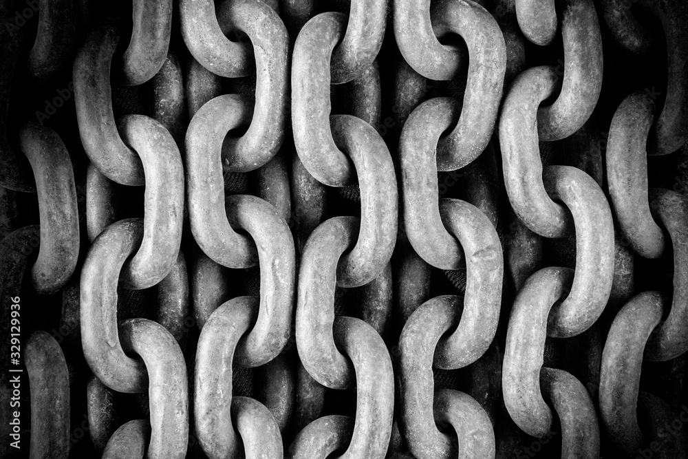 Old rusty chain close-up. Detail of the mechanism. A symbol of strength. Black and white photo. Abstract background. Old rusty chain close-up. Detail of the mechanism. A symbol of strength. Black and white photo. Abstract background.