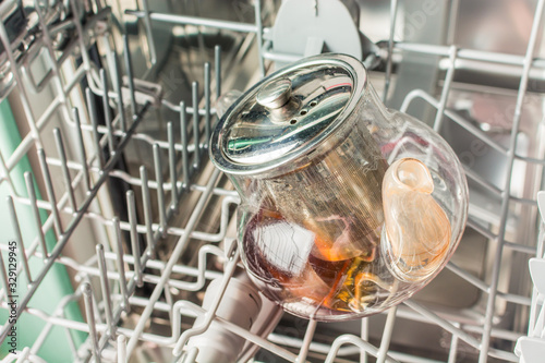Dirty glass teapot lies in the dishwasher