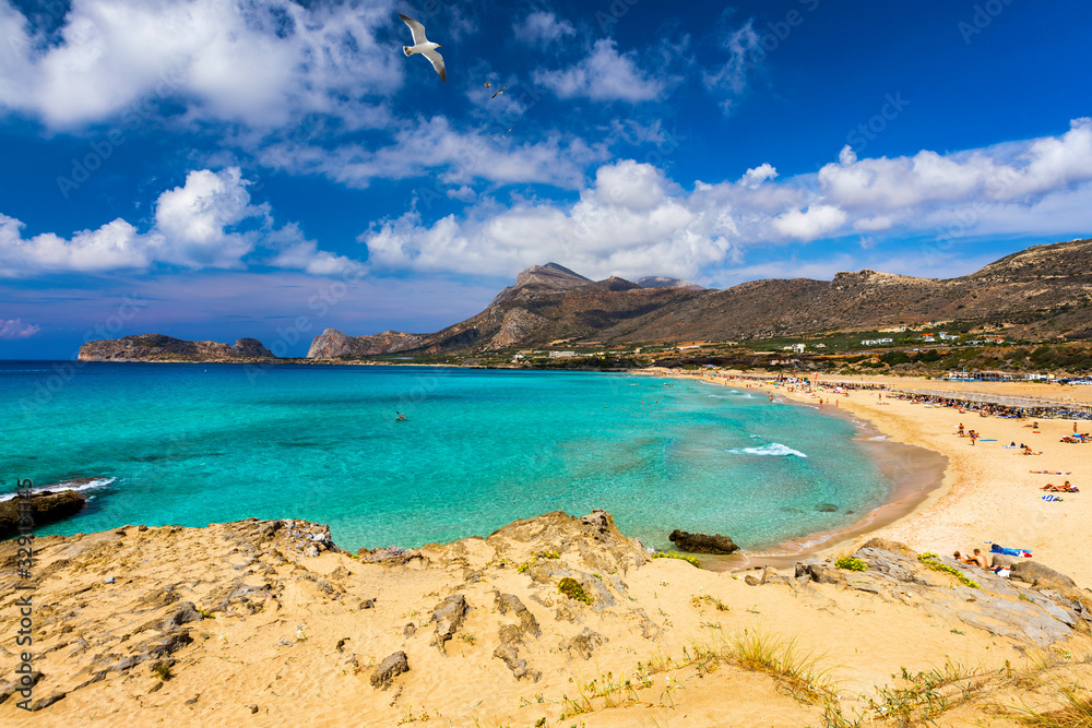 Panorama of turquoise beach Falasarna (Falassarna) in Crete with seagulls flying over, Greece. View of famous paradise sandy deep turquoise beach of Falasarna (Phalasarna), Crete island, Greece.