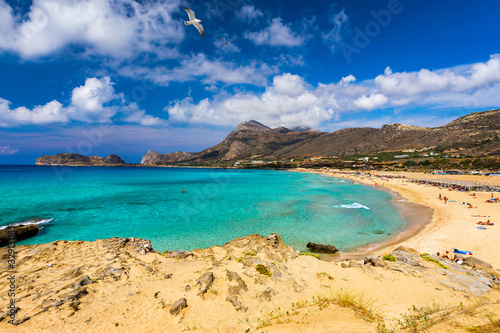 Fototapeta Naklejka Na Ścianę i Meble -  Panorama of turquoise beach Falasarna (Falassarna) in Crete with seagulls flying over, Greece. View of famous paradise sandy deep turquoise beach of Falasarna (Phalasarna), Crete island, Greece.
