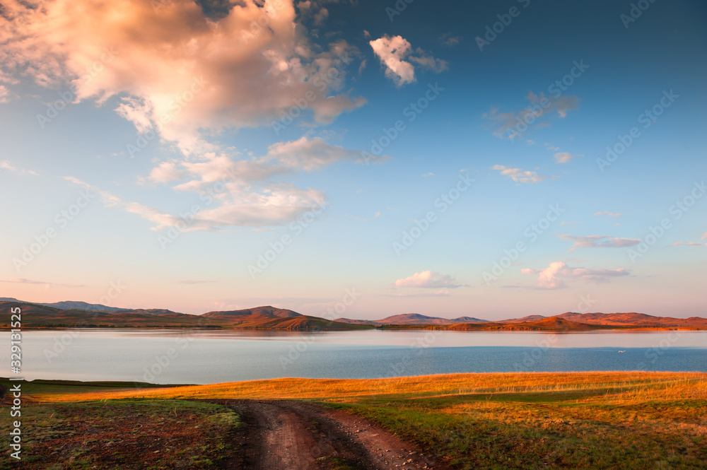 Lake in the autumn mountains at sunset. Beautiful autumn landscape. South Ural, Russia