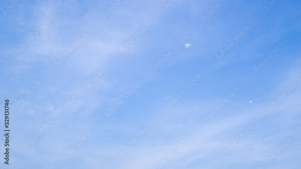 A blue sky with beautiful wisp of cloud for use as a backing or backdrop.