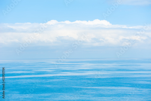 Blue sea background. Beautiful seascape and the blue sky with clouds. Travel destination concept