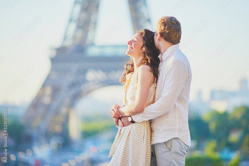 Happy romantic couple in Paris, near the Eiffel tower Happy romantic couple in Paris, near the Eiffel tower