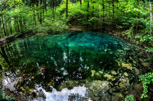 Beautiful and famous emerald colored lake Ochiul Beiului in the woods, forest of Caras Severin county, Beusnita National Park, Cheile Nerei, Bozovici, Romania photo