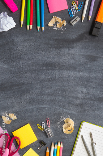 Concept Back To School Chalk Color Pencil Notebook Stationery on Blackboard Background. Design Copy Space Supplies Top View Flat Lay vertical layout