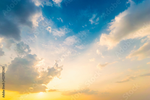Fototapeta Naklejka Na Ścianę i Meble -  Dramadic Sunset Sky blue and orange light of the sun through the clouds in the sky