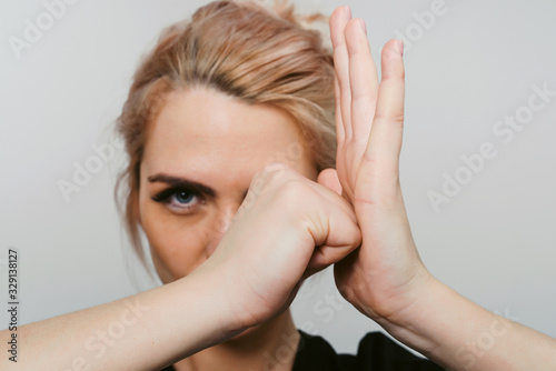 Combative mood! Young woman stretching her arms. Preparing to hard work