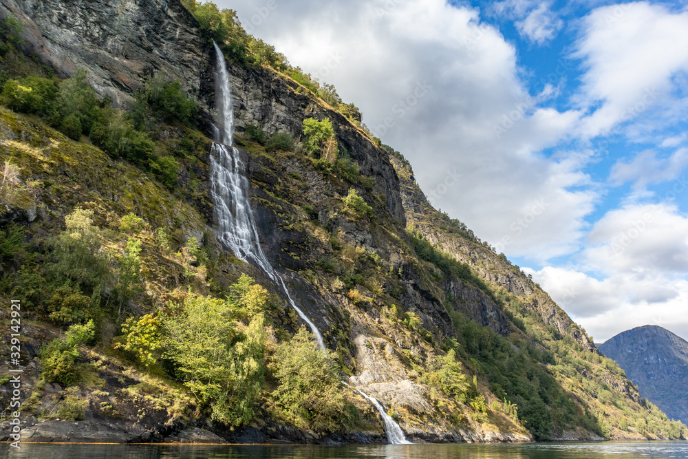 Waterfall falling in norwegian fjord Aurlandsfjord Waterfall falling in norwegian fjord Aurlandsfjord