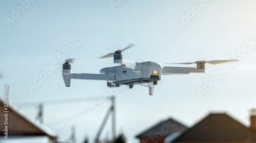 Quadrocopter drone hangs in the air. Shooting photos and videos from a height. Modern technologies of unmanned vehicles