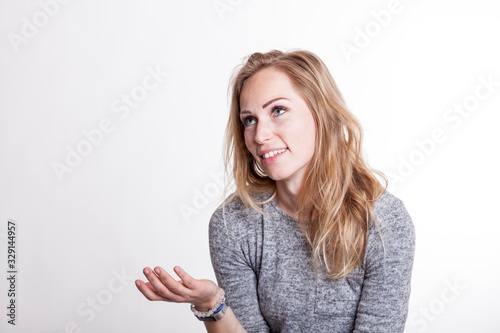 young blond woman argues with open hand