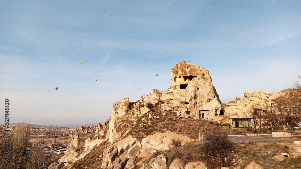 Ancient stone cave houses carved into the volcanic rock in Cappadocia, Turkey