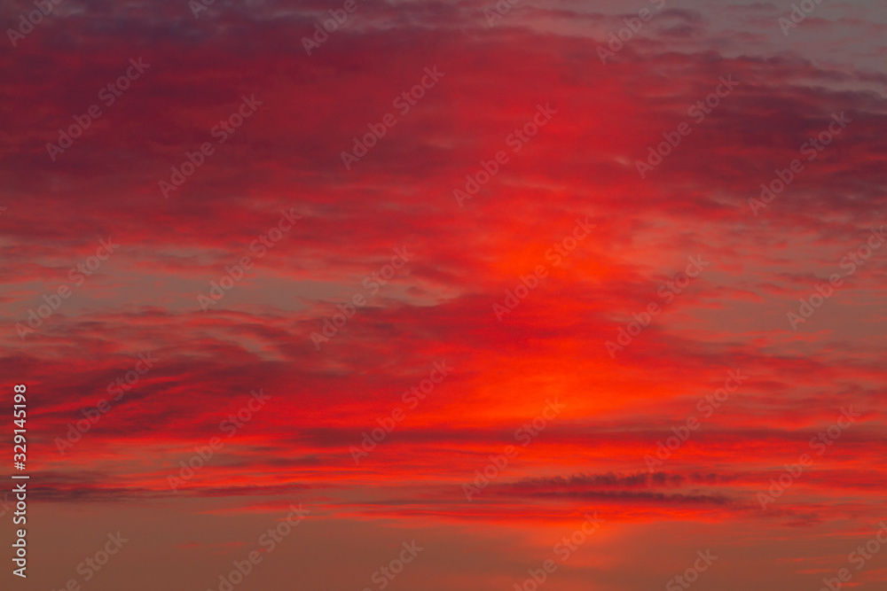 beautiful scarlet sunrise behind the clouds