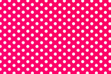 Pink polka dot textured background with white dots