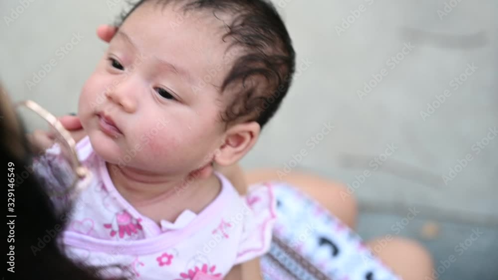 Slow motion of close up view of beautiful young mother playing with her adorable daughter, mother holds baby on her arms. Happy family moment and beautiful asia baby concept background. Slow motion of close up view of beautiful young mother playing with her adorable daughter, mother holds baby on her arms. Happy family moment and beautiful asia baby concept background.