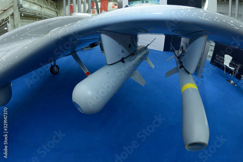 Tactical air-to-ground missiles set on the military unmanned aerial vehicle placed on a stand