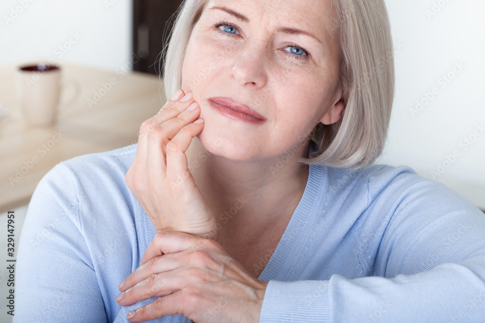 Teeth problem. Woman feeling tooth pain. Closeup of beautiful middle-aged suffering from strong toothache. Attractive female feeling painful toothache. Dental health and care concept. High resolution. Teeth problem. Woman feeling tooth pain. Closeup of beautiful middle-aged suffering from strong toothache. Attractive female feeling painful toothache. Dental health and care concept. High resolution.
