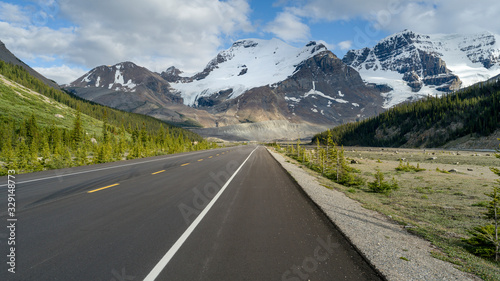 Highway with mountain range in the background, Icefield Parkway, Alberta, Canada