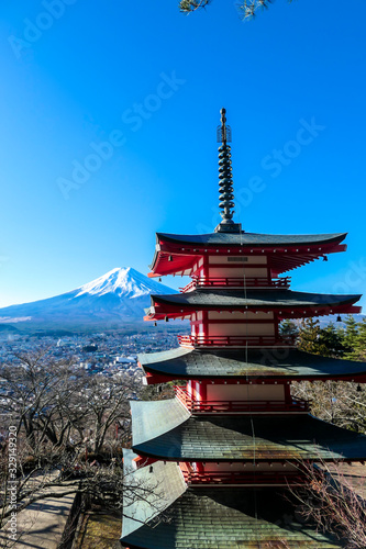 View on Chureito Pagoda and mountain of the mountains Mt Fuji  Japan  captured on a clear  sunny day in winter. Top of the volcano covered with snow. Trees aren t blossoming yet. Postcard from Japan.