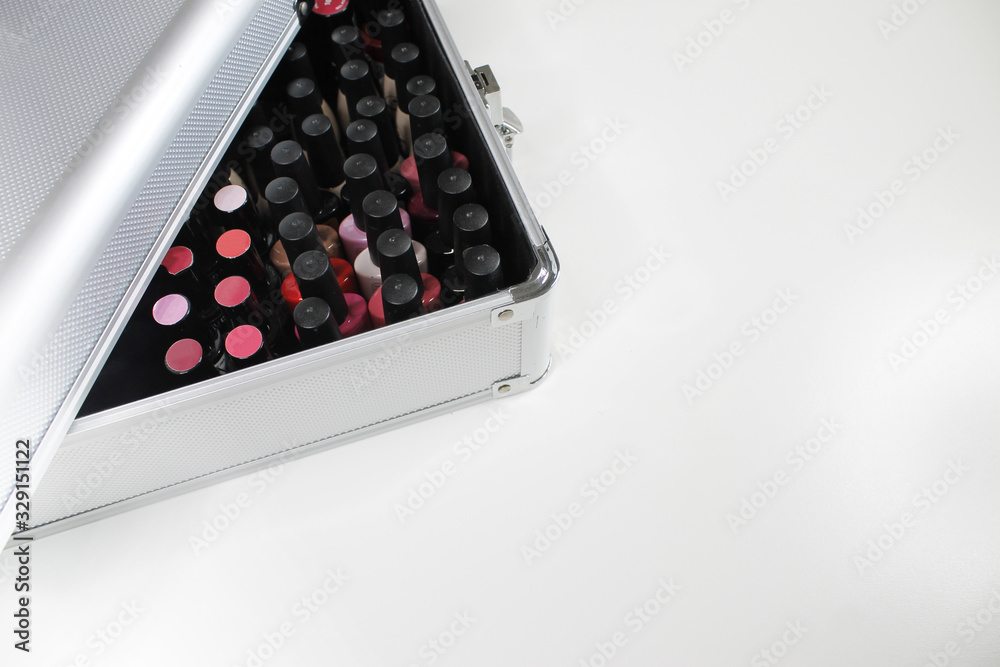 Beauty metal case for nails. Mix of nail painting color bottles in a open case Beauty metal case for nails. Mix of nail painting color bottles in a open case