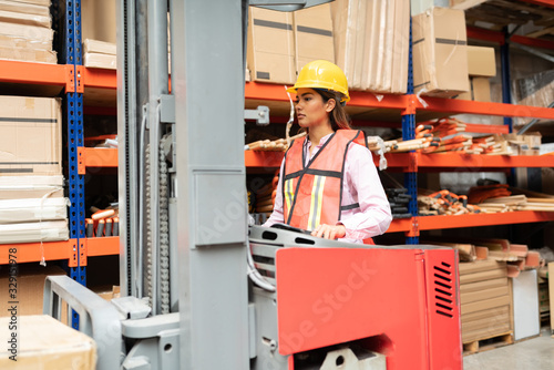 Employee Using Machinery At Warehouse