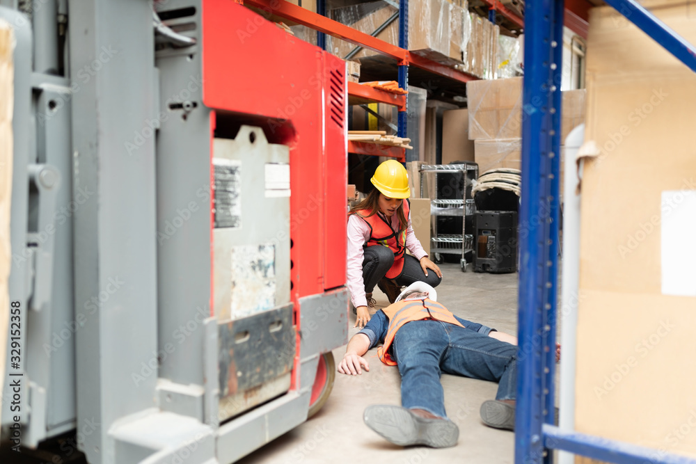 Employee Looking At Worker In Warehouse