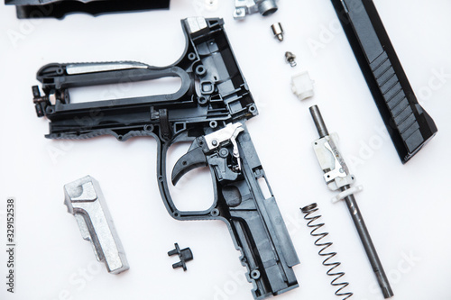 Disassembling an air gun top view, on a white background