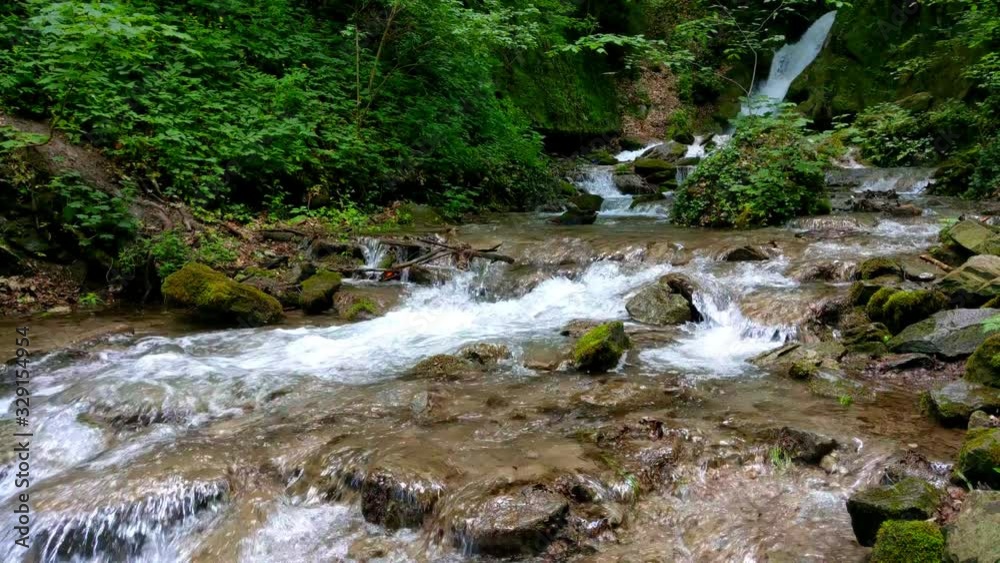 Close up video of a tiny creek with small amount of pure mountain running water Close up video of a tiny creek with small amount of pure mountain running water