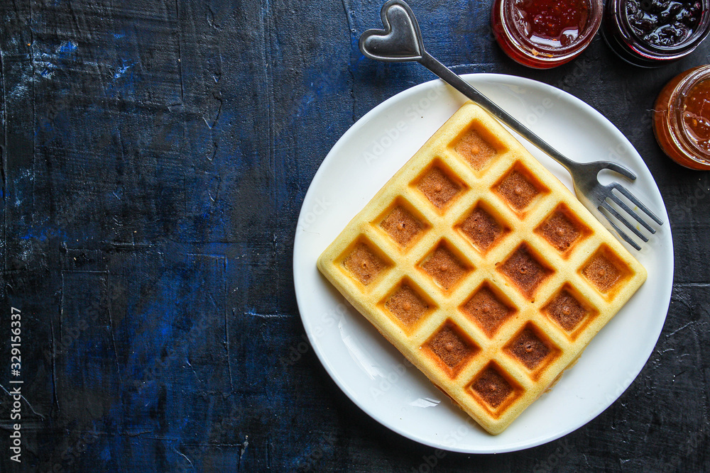 Belgian or Viennese waffles (delicious sweet dish, dessert snack) menu concept. background. top view. copy space for text Belgian or Viennese waffles (delicious sweet dish, dessert snack) menu concept. background. top view. copy space for text
