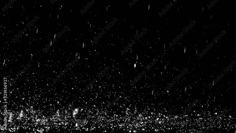 Close up shot of heavy droplets of rain falling on the surface of an isolated background Close up shot of heavy droplets of rain falling on the surface of an isolated background