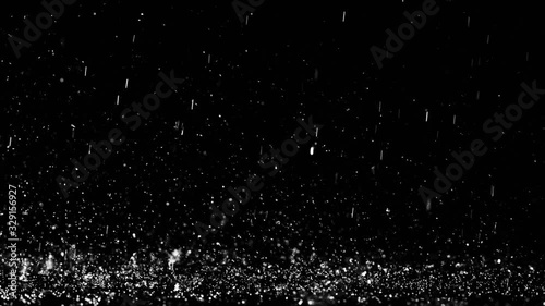 Close up shot of heavy droplets of rain falling on the surface of an isolated background