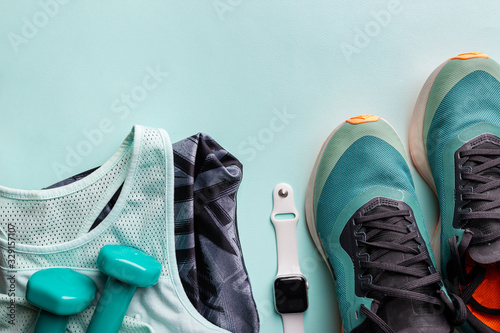 Healthy lifestyle, sport or athlete's equipment set on bright background. Flat lay. Top view with copy space.