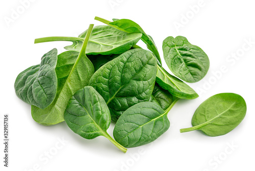 Pile of fresh green baby spinach leaves isolated  on white background. Close up photo