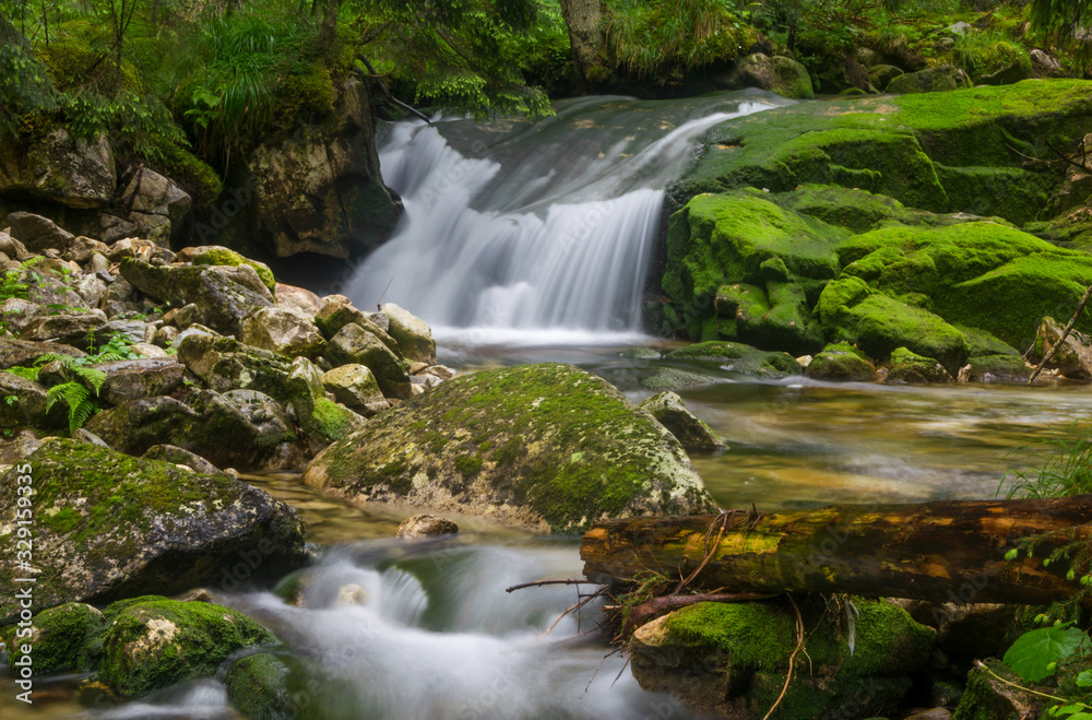 Silky Smooth Waterfall in middle of rain-forest. Waterfall stream in China.