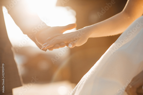 Wedding couple holding hands. Hands of the lovers of the bride and groom. Wedding rings