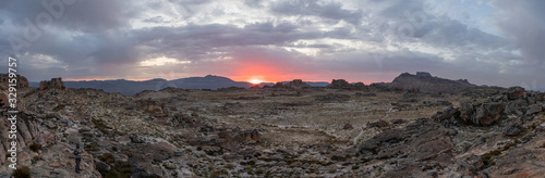 Sunset over barren desert mountain top