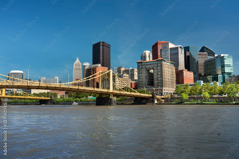 City skyline view over the Allegheny River and Roberto Clemente Bridge in downtown Pittsburgh Pennsylvania USA