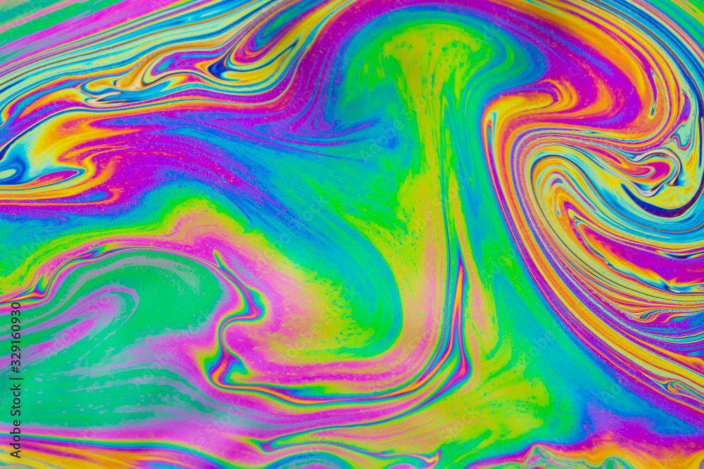 Psychedelic abstract background. Photo macro shot with light interference on the surface of a soap bubble Psychedelic abstract background. Photo macro shot with light interference on the surface of a soap bubble