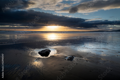 Aberavon beach as the sun sets over the Gower peninsula in Swansea, South Wales UK