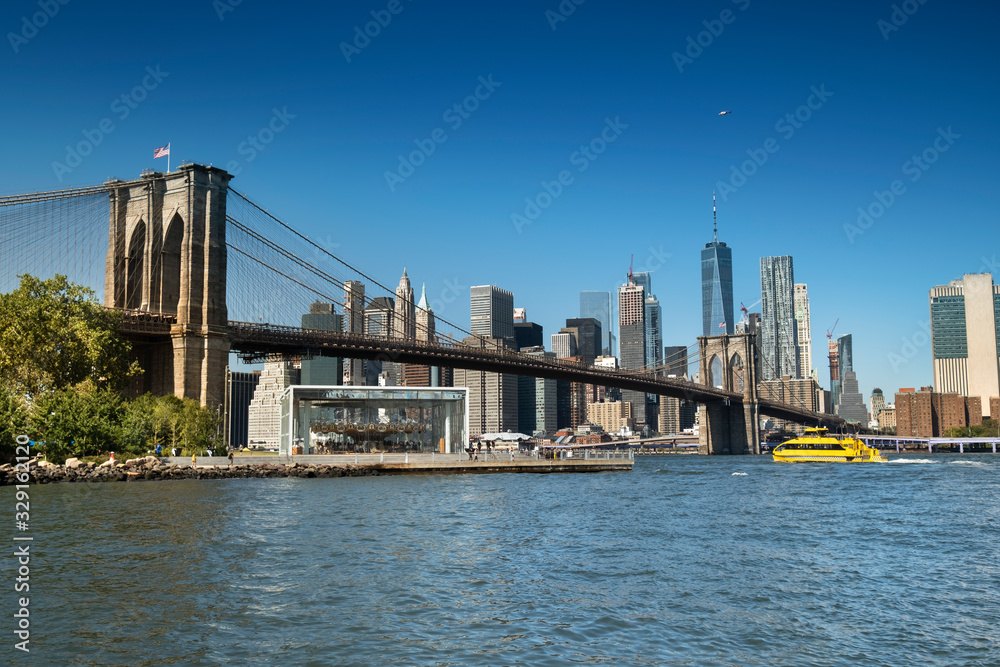 East River shoreline boardwalk under the Brooklyn Bridge as seen from the DUMBO area in New York USA