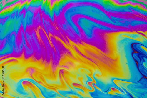 Psychedelic multicolored patterns background. Photo macro shot of soap bubbles