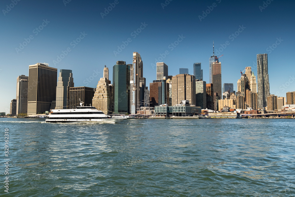 Fototapeta premium Lower Manhattan downtown urban cityscape over the East River from Brooklyn New York USA