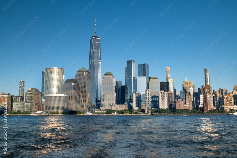 Fototapeta premium Buildings and skyscrapers of the Manhattan urban skyline over the Hudson river in New York USA